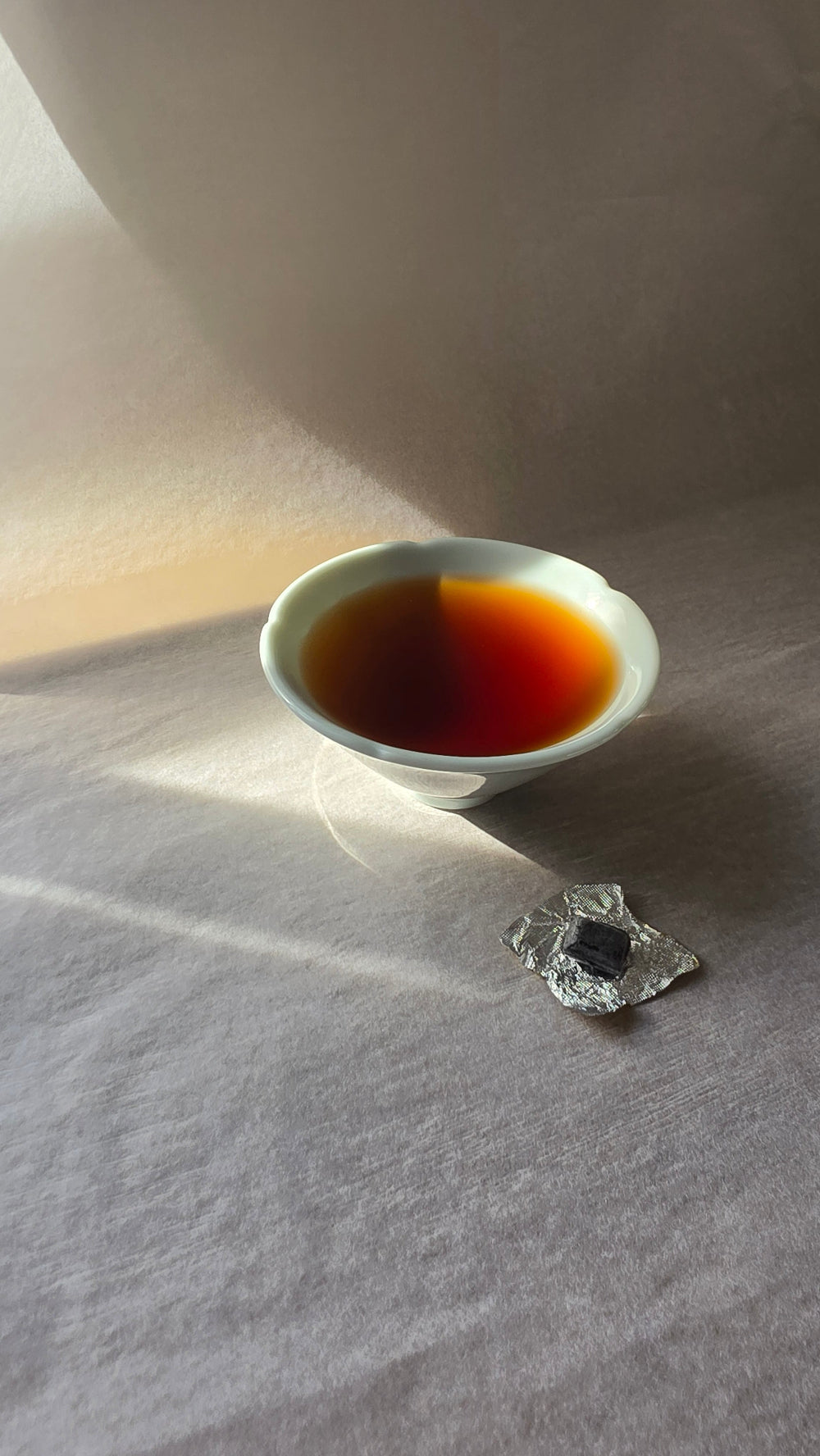 Small teacup with unwrapped tea resin
